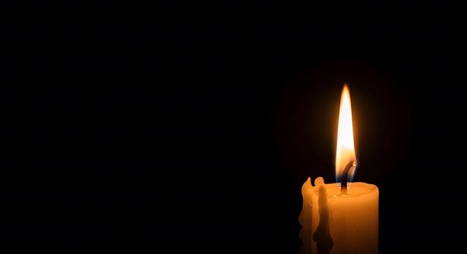 Burning candle in the dark, representing a vigil or loss of a loved one. Simple, atmospheric composition for funeral service invitations and sympathy cards