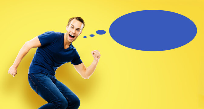Ideas, inspiration, expressing thoughts, sale ad, enthusiasm, success concept - young man jump run with raised hand fist, open-mouthed smile, isolate yellow background. Blue empty think speech bubble