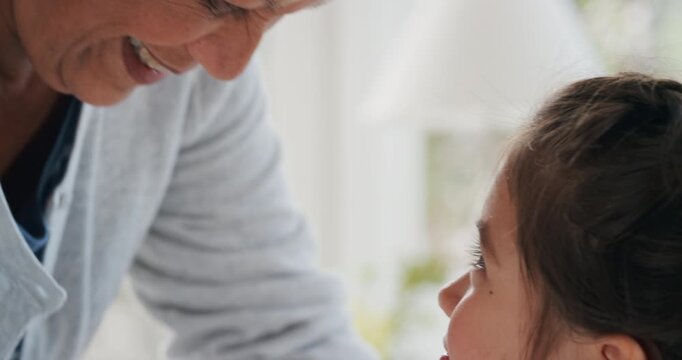 Grandma, child and kiss for care in house, trust and connection together with foster family. Kid, girl and affection with grandmother for love, smile or support for adoption with interracial people