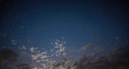 Obraz premium Mellow nocturnal sky decorated by luminous stars and scattered clouds