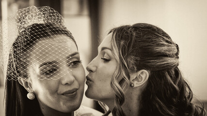 Fototapeta premium Bride sharing a heartfelt moment talking with her sister before the wedding ceremony
