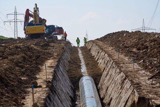 Large pipeline construction site in Ludwigsburg district, Baden-W&uuml;rttemberg, Germany. Workers and machinery install underground pipes for future gas and hydrogen energy supply across agricultural land