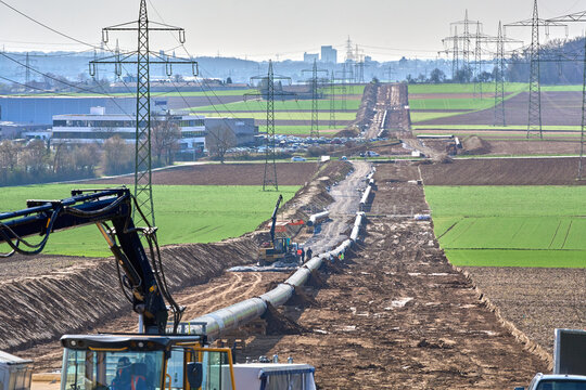 Large pipeline construction site in Ludwigsburg district, Baden-W&uuml;rttemberg, Germany. Workers and machinery install underground pipes for future gas and hydrogen energy supply across agricultural land