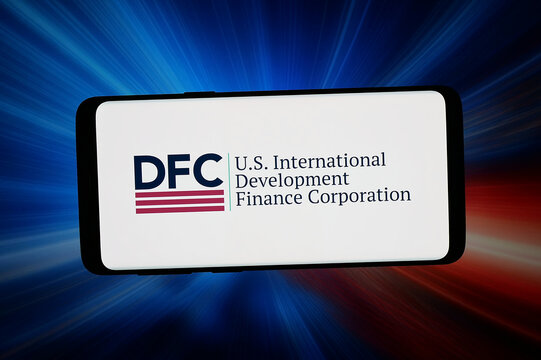 Stuttgart, Germany - 03-19-2026: In this photo illustration, the logo of US finance development corporation DFC is displayed on a smartphone in front of abstract background on computer screen.
