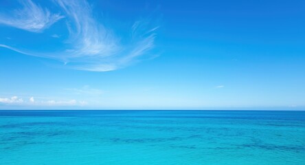 Fototapeta premium Expansive azure sky blending with serene ocean horizon during summer warmth