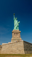 Fototapeta premium Statue of Liberty, Iconic Symbol of Freedom and Democracy in New York Harbor