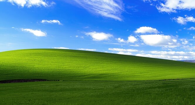 Bright and fresh green hillscape with an open blue sky suitable for nature backgrounds