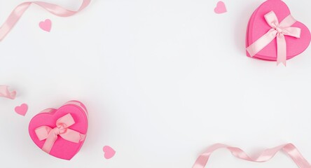 Fototapeta premium Heart shaped pink gift boxes with ribbons on white background top view for Mother's Day celebration