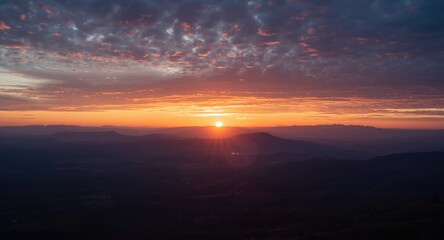 Fototapeta premium Serene mountain sunrise scene with glowing sky at first light