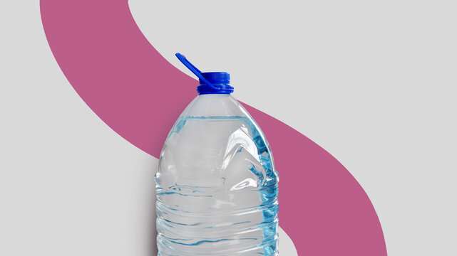 Plastic bottle with drinking water, isolated on grey backdrop with pink line. Transparent 5l bottle, full, blue cap. Clean water supply concept. Horizontal studio shot