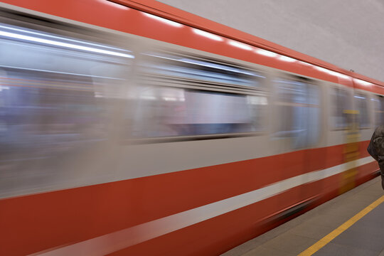 Conveying Sense Of Urgency Through Speeding Subway With Stark Lighting And Urban Surroundings
