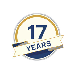 Obraz premium A circular emblem celebrating 17 years, featuring a prominent number 17 and a banner with the word YEARS, outlined in gold and blue.