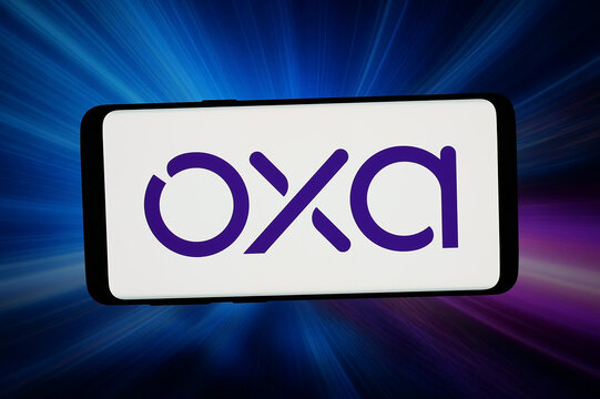 Stuttgart, Germany - 03-19-2026: In this photo illustration, the logo of autonomous driving company Oxa Autonomy is displayed on a smartphone in front of abstract background on computer screen.