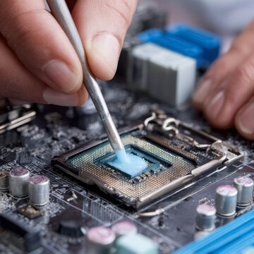Applying thermal paste to CPU processor on computer motherboard