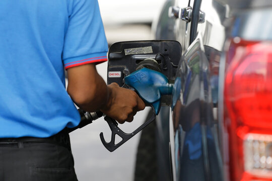 Phnom Penh, Cambodia - June 23, 2022: An attendant refuels a vehicle at a petrol station amid a hike in global gas prices.