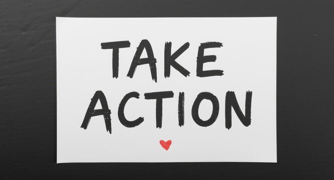 Paper sheet with handwritten TAKE ACTION message on dark backdrop emphasizing real effort