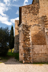 Naklejka premium Abbazia di Sant'Antimo wall with bell tower in Montalcino, Tuscany, Italy.