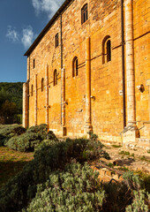 Naklejka premium Abbazia di Sant'Antimo wall with Romanesque architecture in Tuscany, Italy.