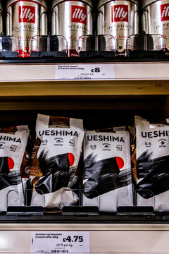 Supermarket Display of Illy and Ueshima Ground Coffee Bags