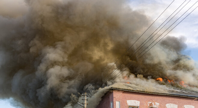 Thick smoke rises from a burning building