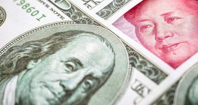 100 dollar banknotes with a hundred yuan note (Renminbi), concept of devaluation of the American currency against Chinese money, financial crisis