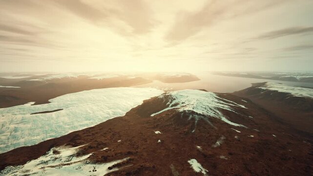 aerial melting glacier and barren ridge at sunrise, visible moraine and exposed bedrock illustrate glacier retreat, environmental research and climate awareness