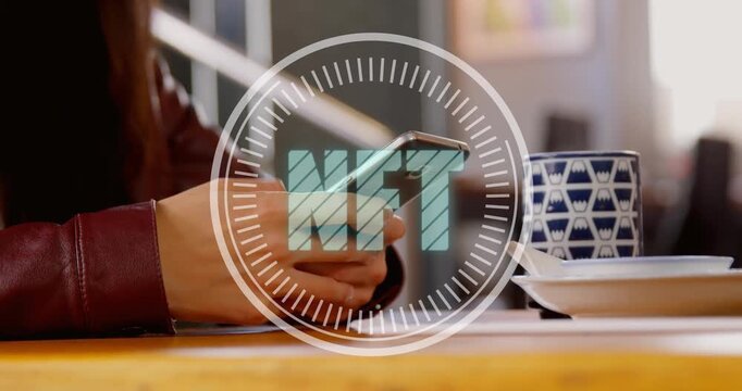 Animation of nft text banner against mid section of a woman using smartphone at office