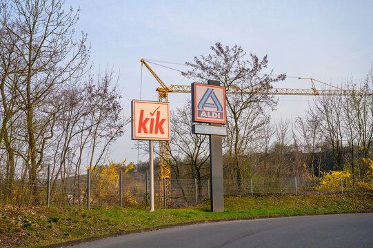 ISERLOHN LETMATHE, GERMANY &mdash; MARCH 23 2026: Aldi and Kik logos on storefronts showing discount retail brands in small town shopping area