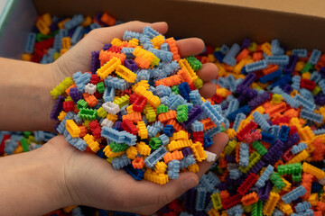Multi-colored small LEGO construction pieces. © Juli