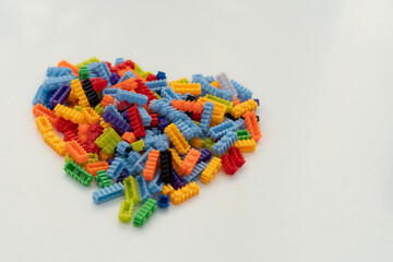 Multi-colored small LEGO construction pieces. © Juli
