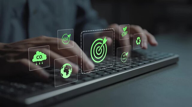 Green business sustainability goals concept. Person typing keyboard with environmental and renewable energy icons, sustainable development, eco friendly practices and corporate responsibility.