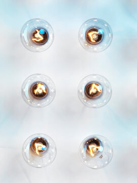 Six lit Incandescent light bulbs