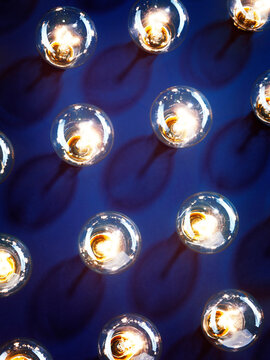 Lit light bulbs on blue background