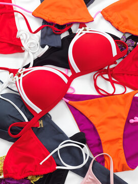 Many colorful bikini swimwear bathing suits fashion background