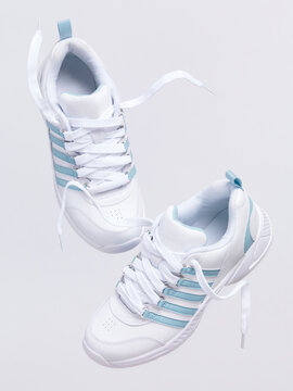 White sports shoes falling down artistic footwear still ife