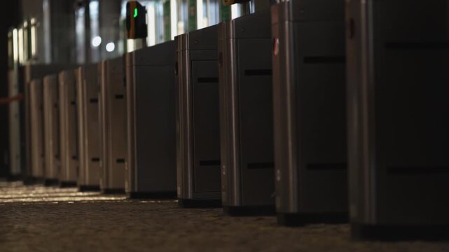 People walking through electronic turnstile gates