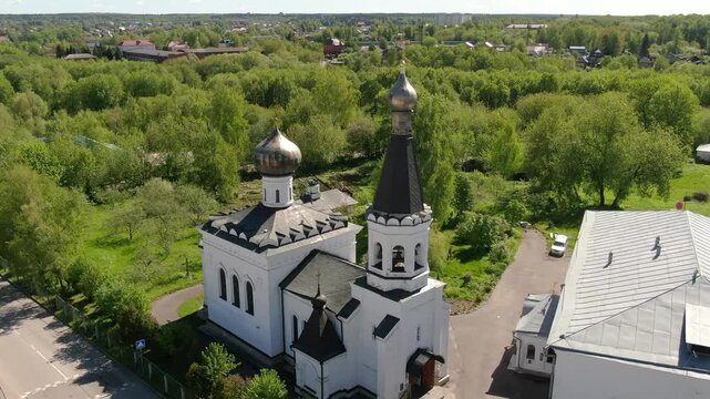 Drone circling church towers in Klin city