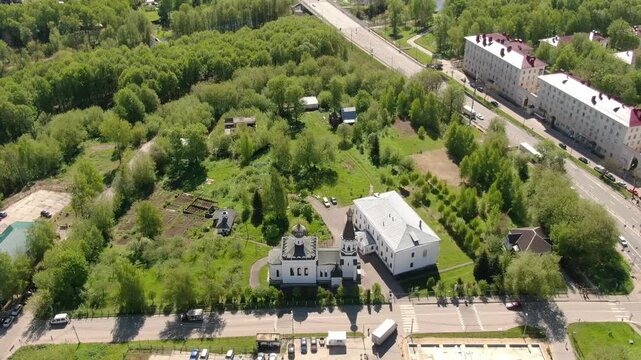 Drone flying backward above church Klin