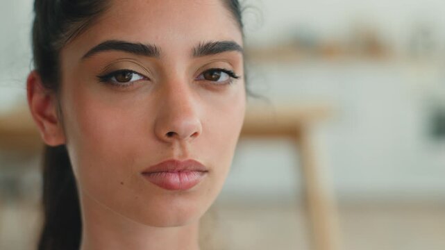 Portrait pensive thinking Indian woman at home look away think looking at camera girl Arabian female serious calm peaceful health problem loan mortgage credit bank at own apartment headshot inside