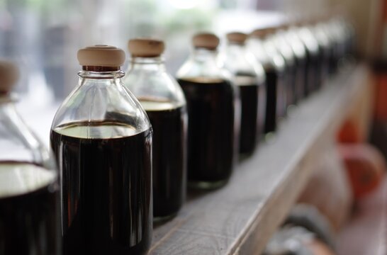 glass bottles of black balsamic vinegar in italian restaurant