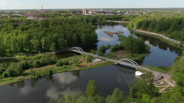 Drone descending forward over river park