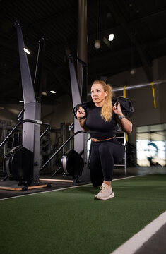 Fitness and health concept. A fit young woman works out in a modern gym. Athletic man doing exercise.