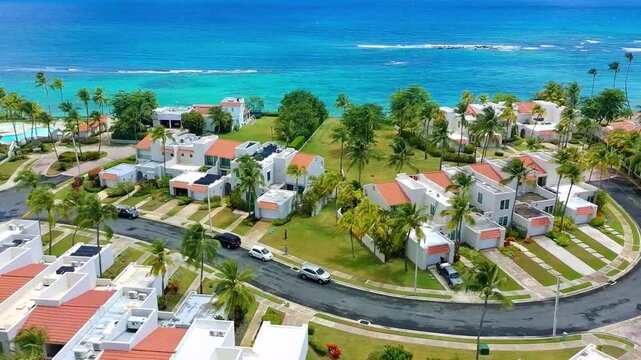 Drone video of various homes and a street next to the beach in Dorado, Puerto Rico
