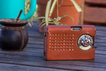 Vintage transistor radio and mate cup on wooden table © Fernando