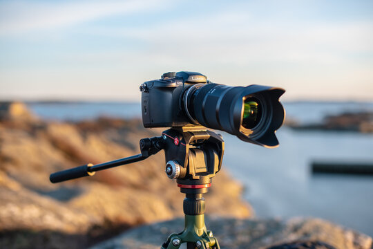 Gothenburg, Sweden - April 01 2019: Professional mirrorless camera on tripod overlooking coastal landscape.