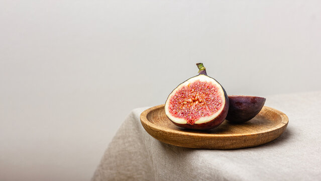 Fresh cut figs on a light background.