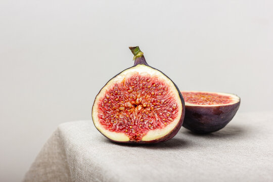 Fresh cut figs on a light background.