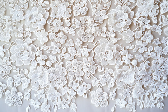 Large, layered floral blossoms are linked by delicate thread bridges in this creamy ivory guipure lace, creating a dimensional, sculptural texture with an elegant and timeless aesthetic