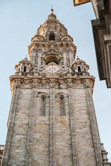 Obraz premium Ornate bell tower of the Santiago de Compostela Cathedral, a UNESCO World Heritage site and a significant pilgrimage destination, showing intricate Baroque architecture against a clear sky
