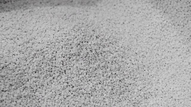 Close-up of white gravel surface. Texture details clearly visible. Natural, unedited, realistic appearance. Ideal for construction or landscaping themes. Neutral tones enhance versatility